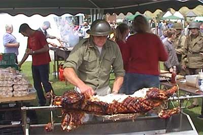 Eddie Hatcher hard at work on the hog roast - we're not sure if the tin helmet was part of his costume or to protect him from customers! 