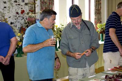 Gardening Club Chairman, Geoff Hawkins (right) explains the finer points of a carrot to Mark Carr 