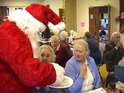 Santa hands out candy canes to all who attended